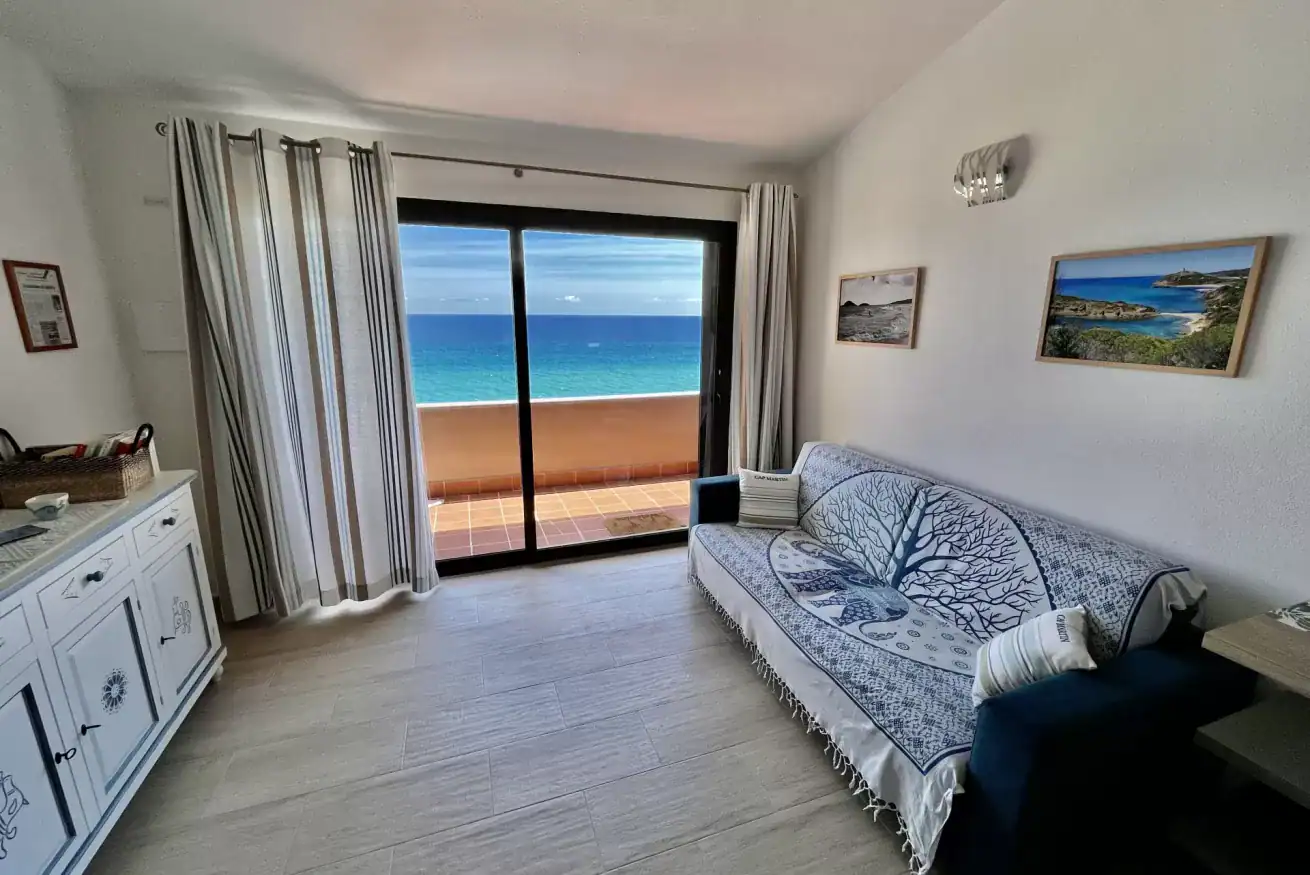 the interior of a living room with a sea view
