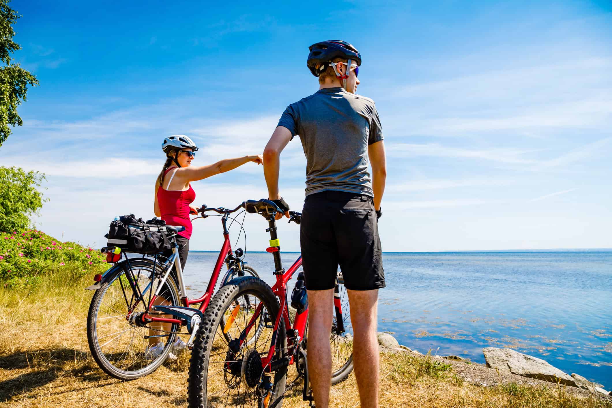 couple cycling near the sea