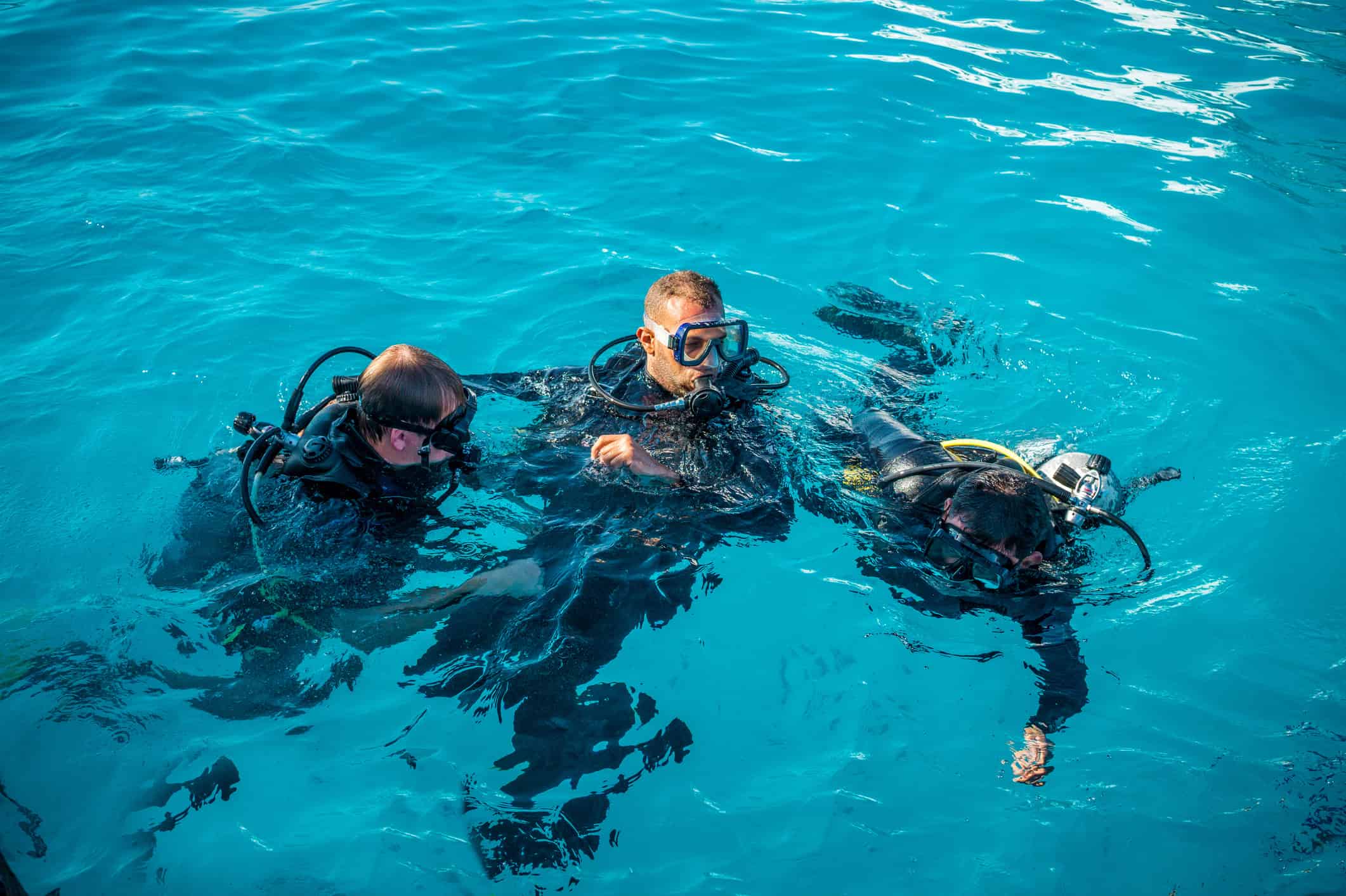 diving instructor with students in the water
