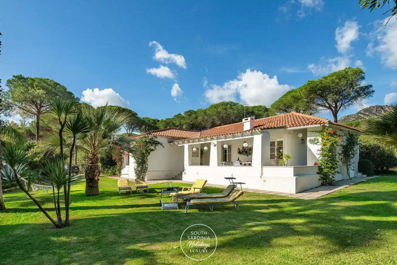 a house with a garden and sun loungers